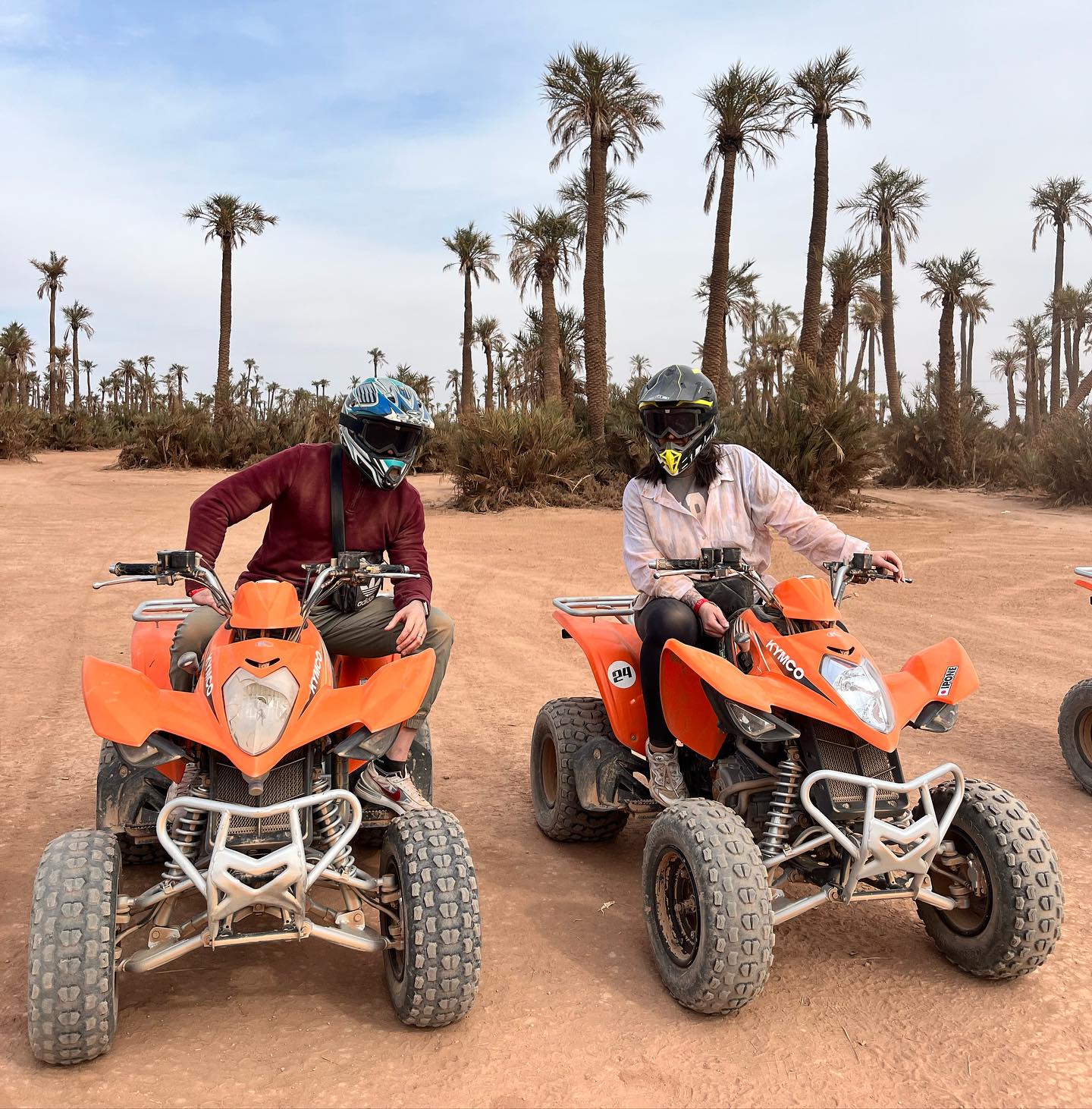 2 poeple in quad bike riding the palm grove of marrakech