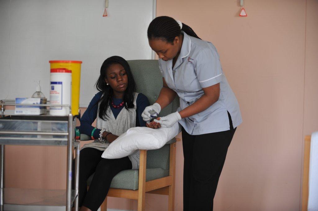 Student nurse administering an injection