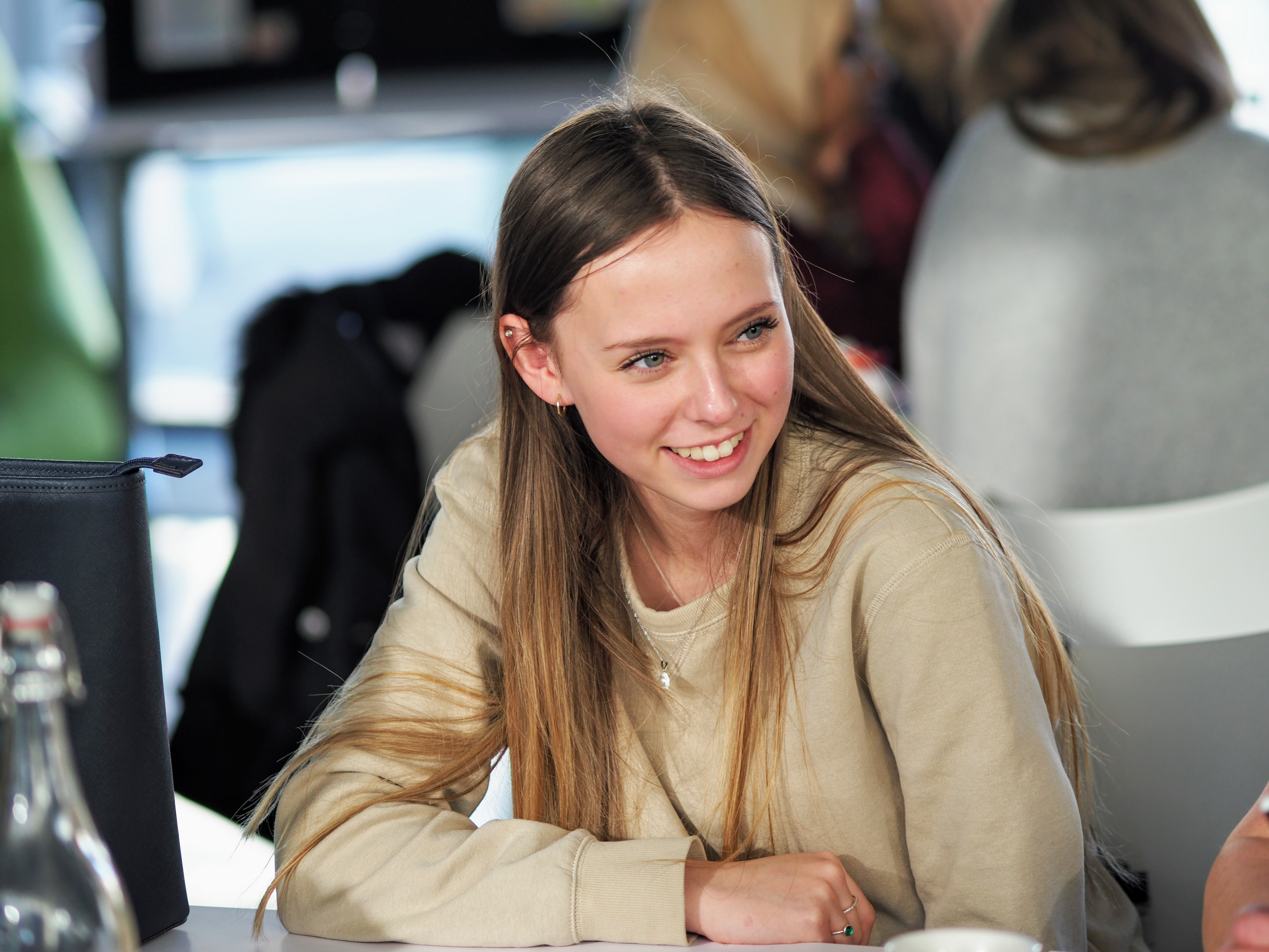 A female with long brown hair taking part in a design thinking workshop.